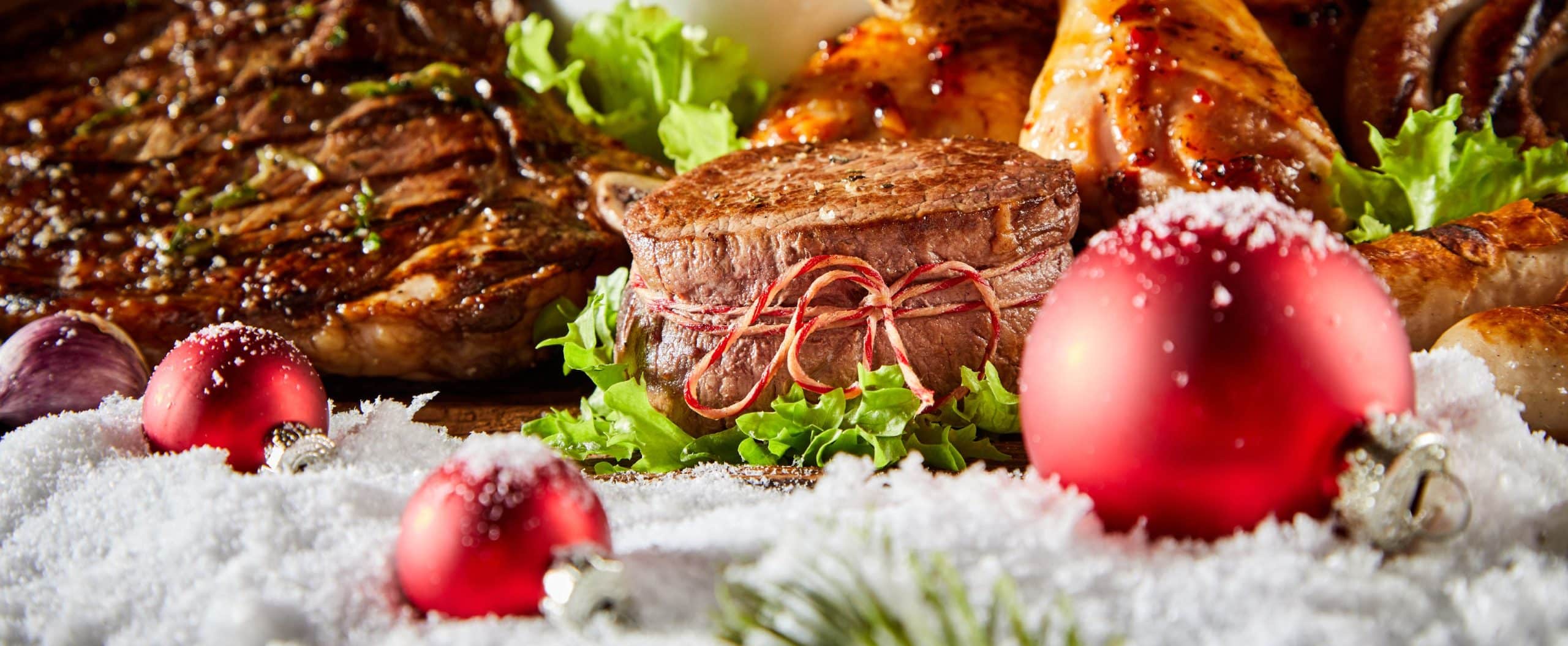 grilled meat surrounded by fake snow and christmas ornaments