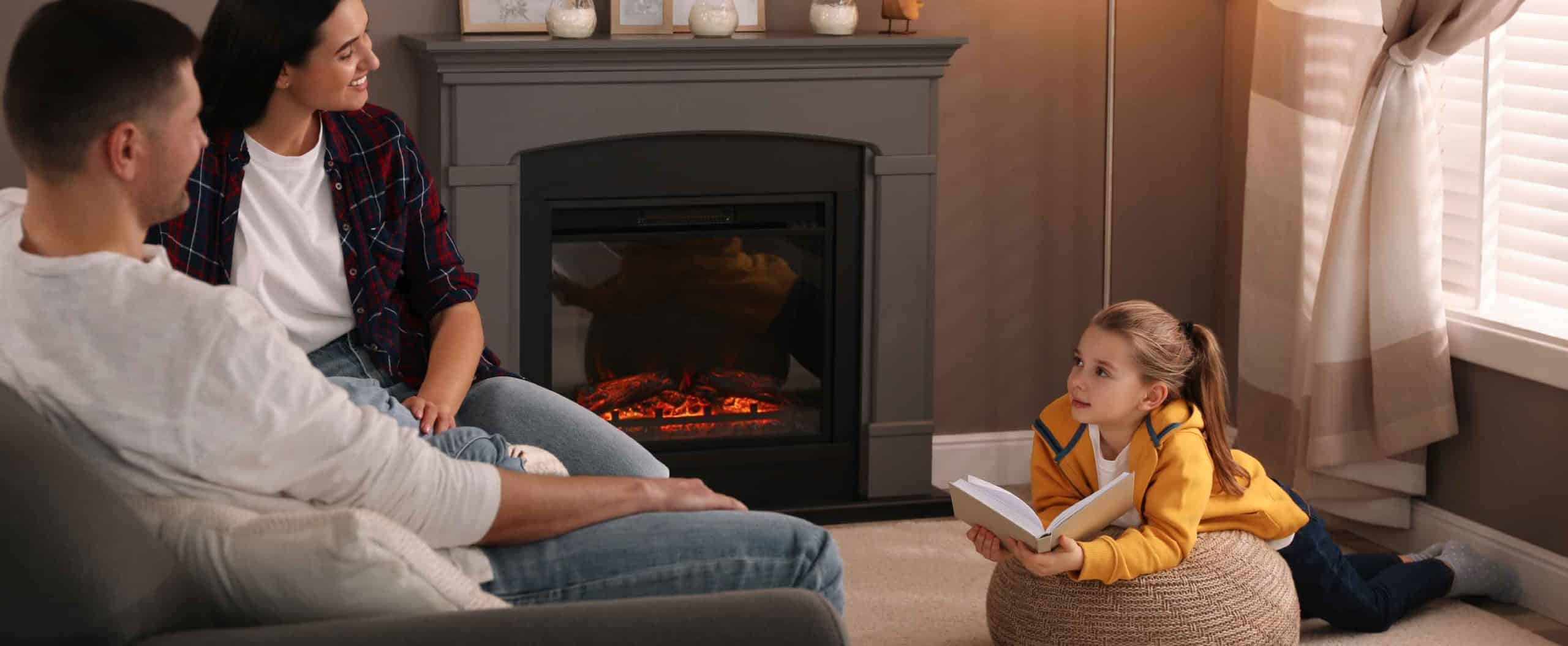 family gathered around fireplace child reading